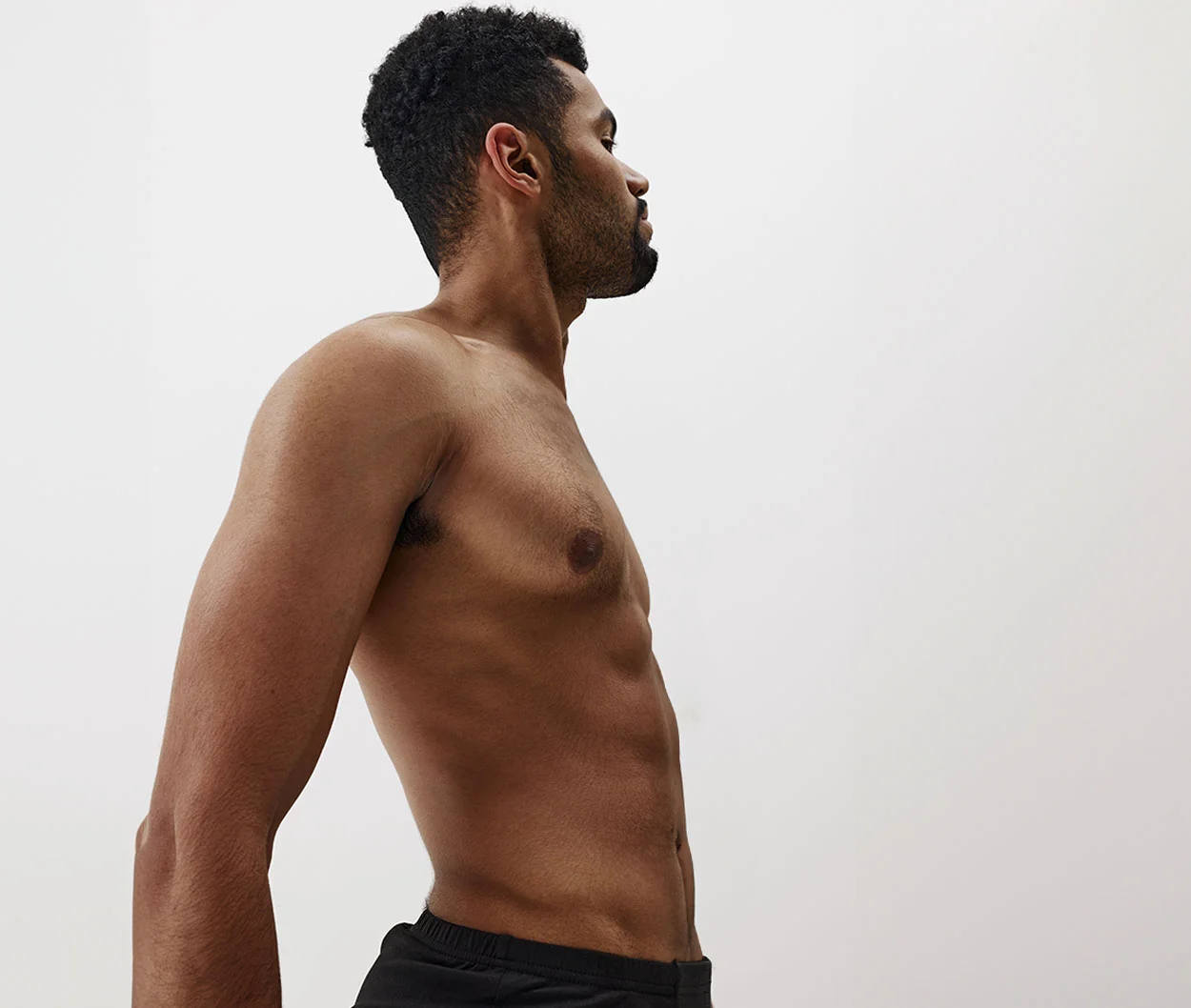 A man shirtless against a neutral background - Abdominal Wall Reconstruction at Eleve Plastic Surgery